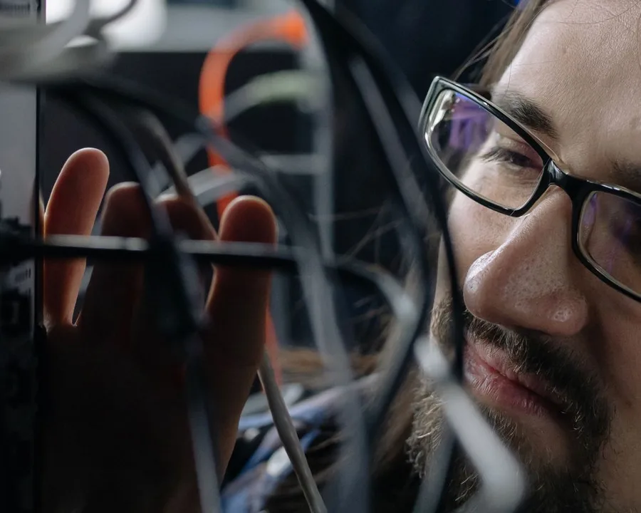 IT technician working on business network cabling