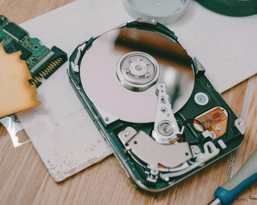 Open hard disk drive showing the internal platter during data recovery