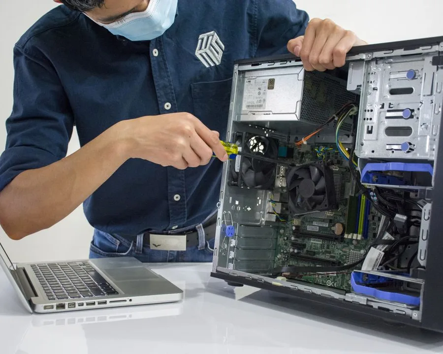 Technician repairing the internals of a desktop PC tower